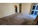 Inviting living room with easy access to the kitchen and a classic paneled interior door at 509 California Cir, York, SC 29745