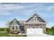 Charming single-Gathering home featuring stone accents, a two-car garage, and professionally landscaped front yard at 554 Nesbe St # 2294, Lancaster, SC 29720