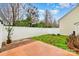 Fenced backyard with partial brick and concrete patio and green space at 618 Bayou Cir, Clover, SC 29710