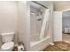 Bright bathroom featuring white tile shower-tub combination and white toilet at 618 Bayou Cir, Clover, SC 29710