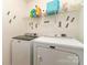 Efficient laundry room featuring modern washer and dryer with storage shelf at 618 Bayou Cir, Clover, SC 29710