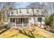 Two story house showing back with white siding and a covered back porch at 6525 Castlegate Dr, Charlotte, NC 28226