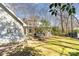 View of the back of the house and backyard with some trees and a small shed at 6525 Castlegate Dr, Charlotte, NC 28226
