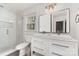 Clean bathroom with double vanity, modern fixtures, a glass-enclosed shower, and natural light at 6525 Castlegate Dr, Charlotte, NC 28226