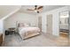 Bright bedroom with a comfortable bed, neutral accents, and an ensuite bathroom at 6525 Castlegate Dr, Charlotte, NC 28226