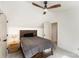 Neutral bedroom with a sleek ceiling fan, dark wood bed frame, and well-placed lighting at 6525 Castlegate Dr, Charlotte, NC 28226