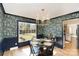 Inviting dining room with stylish wallpaper, wainscotting, and a modern chandelier fixture at 6525 Castlegate Dr, Charlotte, NC 28226