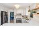 Updated kitchen featuring white cabinets, stainless appliances, light countertops, and a pendant light fixture above the sink at 6525 Castlegate Dr, Charlotte, NC 28226
