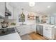 Bright kitchen featuring white cabinets, quartz countertops, floating shelves, and stainless steel appliances at 6525 Castlegate Dr, Charlotte, NC 28226