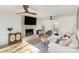 Inviting living room with a brick fireplace, comfortable seating, modern decor, hardwood flooring, and ample natural light at 6525 Castlegate Dr, Charlotte, NC 28226