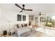 Cozy living room featuring a comfortable sectional sofa, hardwood floors, wainscoting, and plenty of natural light at 6525 Castlegate Dr, Charlotte, NC 28226