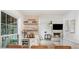 Open living area with a wine fridge, white cabinets, floating shelves, and a view of the fireplace at 6525 Castlegate Dr, Charlotte, NC 28226