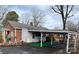 Back exterior of home with a covered parking area and partial brick wall at 708 Mount Olive Church Rd, Newton, NC 28658