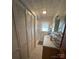 Bright bathroom featuring tiled floors, ample storage, and a walk-in shower at 708 Mount Olive Church Rd, Newton, NC 28658