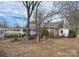 Charming single-story brick home with a covered porch, mature trees, and a landscaped front yard at 708 Mount Olive Church Rd, Newton, NC 28658
