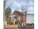 Charming red brick house with mature trees and a quaint front garden at 708 Mount Olive Church Rd, Newton, NC 28658