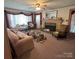 Charming living room with vintage decor, a cozy fireplace, and ample seating at 708 Mount Olive Church Rd, Newton, NC 28658