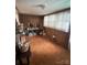 Sunroom featuring paneled walls, carpet, and natural light from a window at 708 Mount Olive Church Rd, Newton, NC 28658