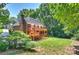 Multi-level wooden deck with stairs leading to a well-maintained backyard with lush greenery at 8000 Greencastle Dr, Charlotte, NC 28210