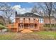 Beautiful backyard showcasing multi-level deck, brickwork, and lush greenery create a serene outdoor setting at 8000 Greencastle Dr, Charlotte, NC 28210