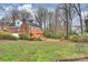 Spacious backyard featuring lush lawn, mature trees, and a multi-level deck, ideal for outdoor relaxation at 8000 Greencastle Dr, Charlotte, NC 28210
