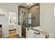 En suite bathroom with glass enclosed shower, view to bedroom, tile floors, and neutral paint at 8000 Greencastle Dr, Charlotte, NC 28210
