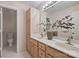 Bathroom features double sinks, wood cabinetry, and white tiled floors at 8000 Greencastle Dr, Charlotte, NC 28210
