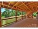 Under-deck view shows wood construction with lattice, offering shade and a view of the landscape at 8000 Greencastle Dr, Charlotte, NC 28210