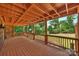 Inviting covered deck featuring a wooden structure, providing shade and a view of the landscaped yard at 8000 Greencastle Dr, Charlotte, NC 28210