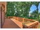 Spacious wooden deck perfect for outdoor entertaining with a view of the lush backyard at 8000 Greencastle Dr, Charlotte, NC 28210