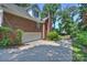 Brick home with a two-car garage and a paved driveway leading to a gated entrance at 8000 Greencastle Dr, Charlotte, NC 28210