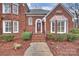 Inviting front entrance with brick steps and a detailed brick facade at 8000 Greencastle Dr, Charlotte, NC 28210