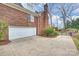 Exterior view highlighting the attached garage and brick facade, complemented by a well-maintained driveway at 8000 Greencastle Dr, Charlotte, NC 28210