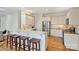 A kitchen with a breakfast bar featuring stainless steel appliances and white cabinetry at 8000 Greencastle Dr, Charlotte, NC 28210