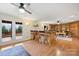 Spacious room with a bar area, hardwood floors, and outside access to the home's wooden deck at 8000 Greencastle Dr, Charlotte, NC 28210