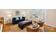 Cozy living room featuring hardwood floors, a large bay window, and comfortable seating at 8000 Greencastle Dr, Charlotte, NC 28210