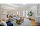 Open-concept living room with a skylight, hardwood floors, and access to the outdoors through French doors at 8000 Greencastle Dr, Charlotte, NC 28210