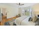 This spacious main bedroom offers hardwood floors, a chair, and a cozy rug and view of the backyard at 8000 Greencastle Dr, Charlotte, NC 28210