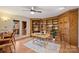 Office room with wood bookcase and cabinets, wood floors, and a door leading to the deck at 8000 Greencastle Dr, Charlotte, NC 28210