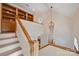 Beautiful staircase with natural wood and white risers leading to second story with built-in shelving at 8000 Greencastle Dr, Charlotte, NC 28210