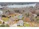 Aerial view of a home with a large lot surrounded by trees, with lake in background at 8143 Summit Ridge Dr # 41, Catawba, NC 28609