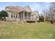 Backyard view of screened porch, patio, and stone retaining walls at 8143 Summit Ridge Dr # 41, Catawba, NC 28609
