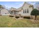 Backyard view of screened porch, patio, and stone retaining walls with professional landscaping at 8143 Summit Ridge Dr # 41, Catawba, NC 28609