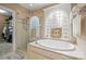 Bathroom with luxurious tub, separate glass shower, and elegant tile work and arched window at 8143 Summit Ridge Dr # 41, Catawba, NC 28609