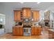 Kitchen featuring stainless steel appliances, wood cabinets, granite countertops, and a view of the living room at 8143 Summit Ridge Dr # 41, Catawba, NC 28609