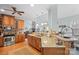 Spacious kitchen featuring a large island with seating, wood cabinets, stainless steel appliances, and a stone fireplace at 8143 Summit Ridge Dr # 41, Catawba, NC 28609