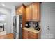 Kitchen area features stainless steel refrigerator, wood cabinets, granite countertops, and access to laundry room at 8143 Summit Ridge Dr # 41, Catawba, NC 28609