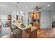 Well-lit kitchen featuring granite countertops, wood cabinets, stainless steel appliances, and barstool seating at 8143 Summit Ridge Dr # 41, Catawba, NC 28609