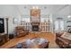Living room boasts stone fireplace, hardwood floors, built-in bookcases and windows overlooking a serene outdoor space at 8143 Summit Ridge Dr # 41, Catawba, NC 28609