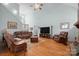 Spacious living room with high ceilings, hardwood floors, leather furniture, and a fireplace at 8143 Summit Ridge Dr # 41, Catawba, NC 28609